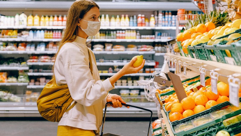 A woman wearing a face mask shops for fruits in a supermarket during a pandemic., tags: neena's waar jaar - pexel